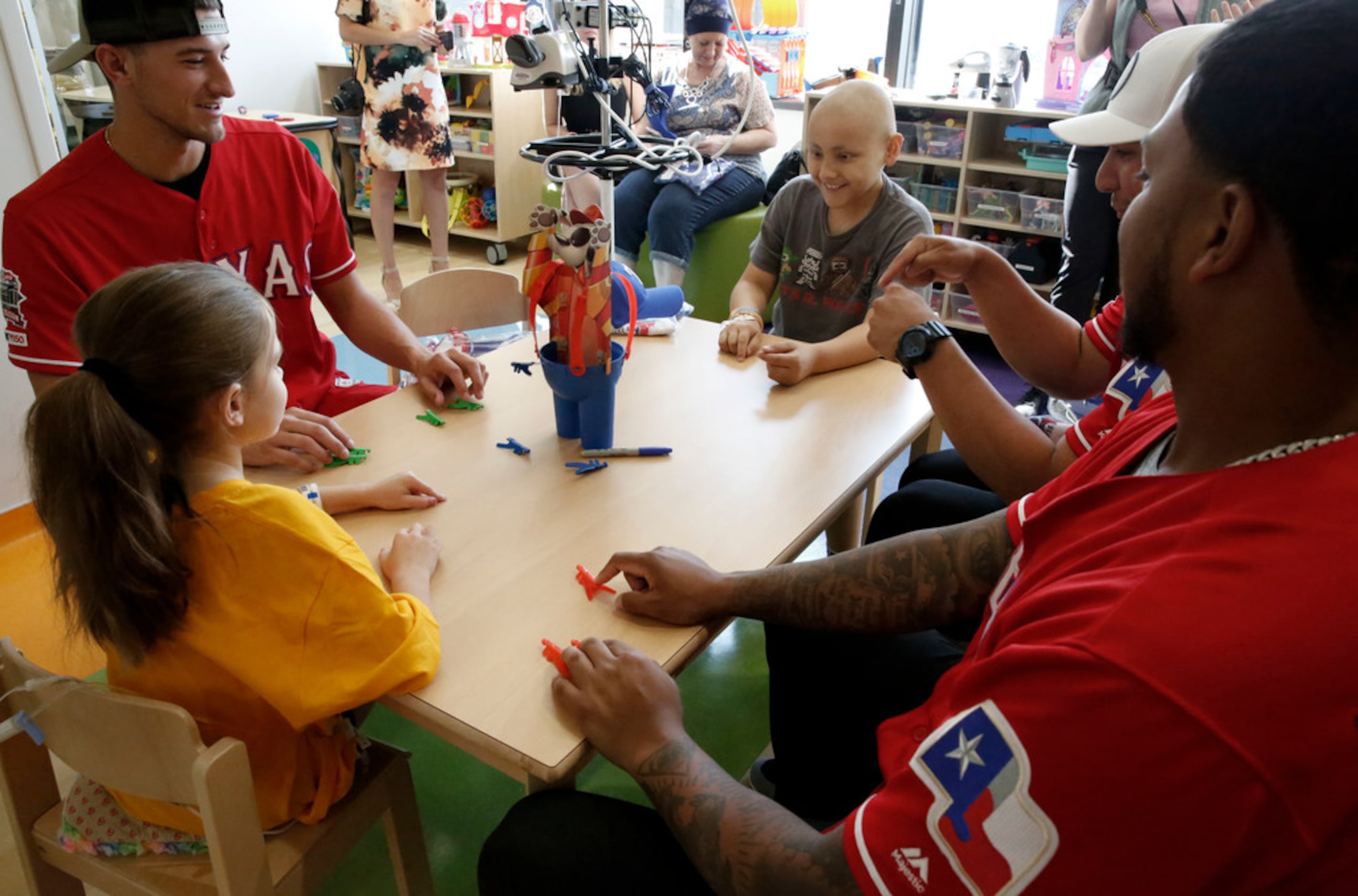 Texas Rangers pitcher Brett Martin, left 10-year-old patient Camilo LÃ³pez, catcher Jose...