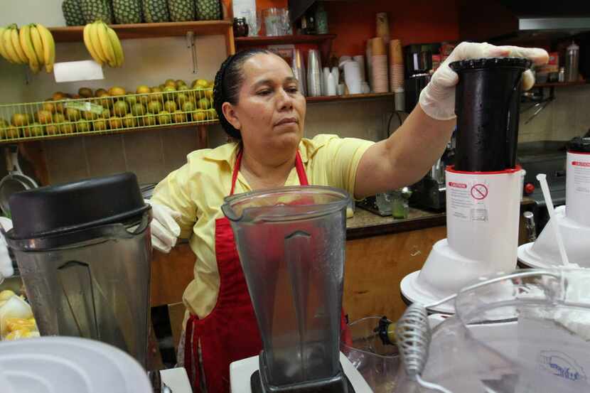 Celina Alvarez, 51, works at Jugueria de regreso al Eden, her shop in the Queens borough of...