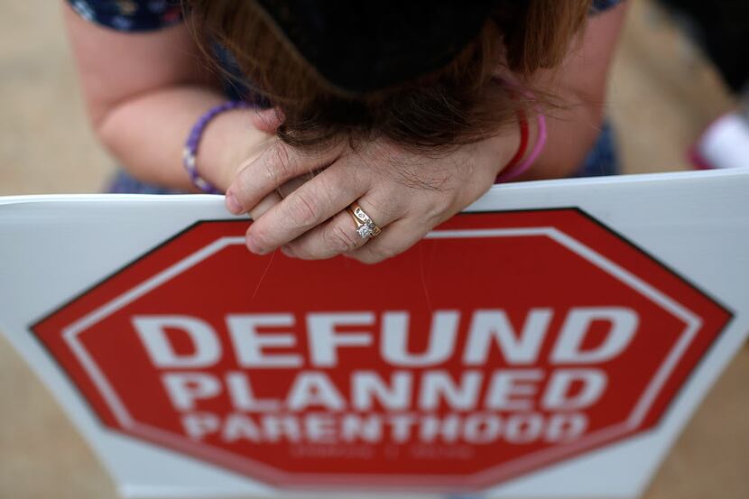  Right to Life advocate Linda Heilman prays during a sit-in in front of a proposed Planned...