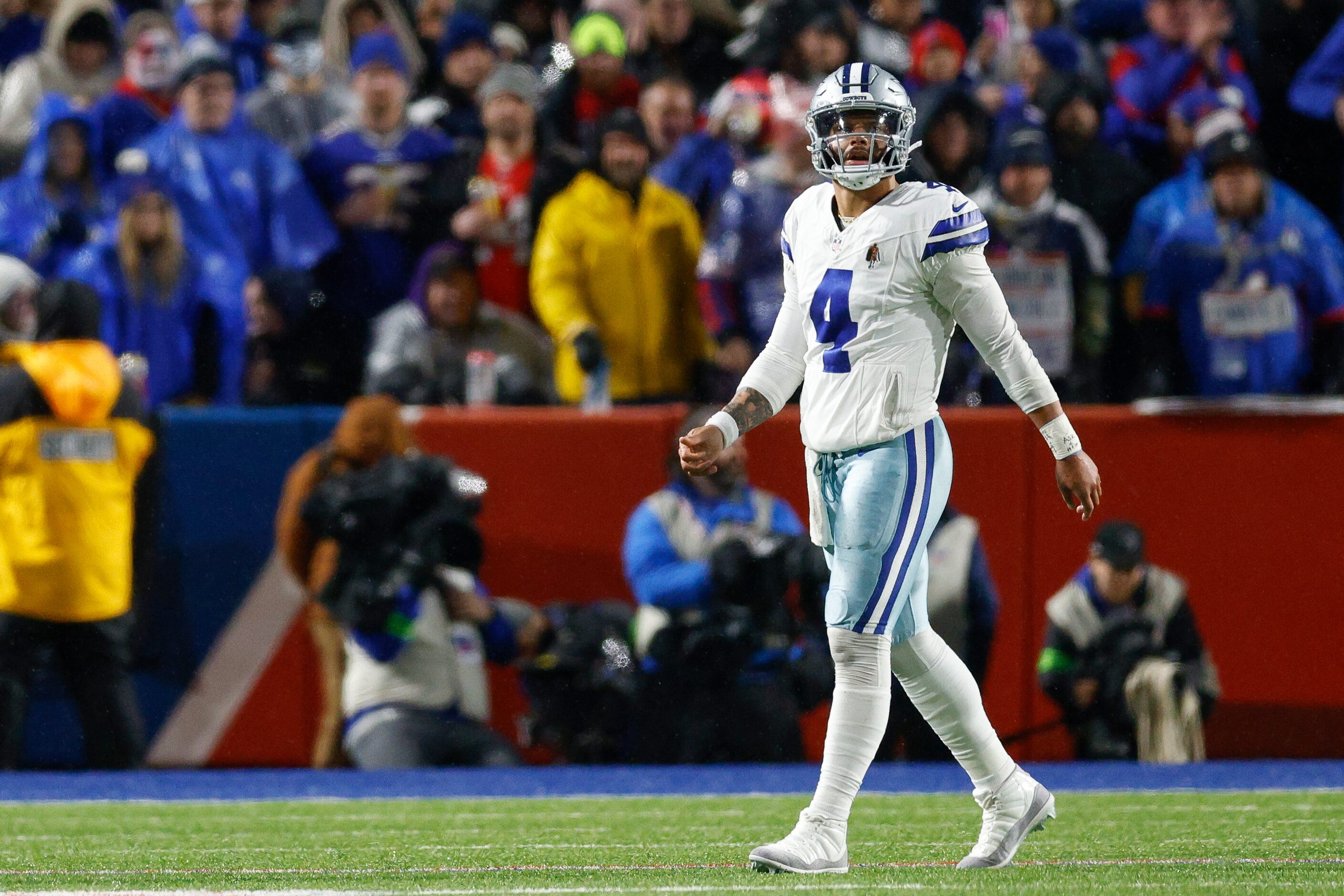 Dallas Cowboys quarterback Dak Prescott (4) walks off the field after failing to pick up a...