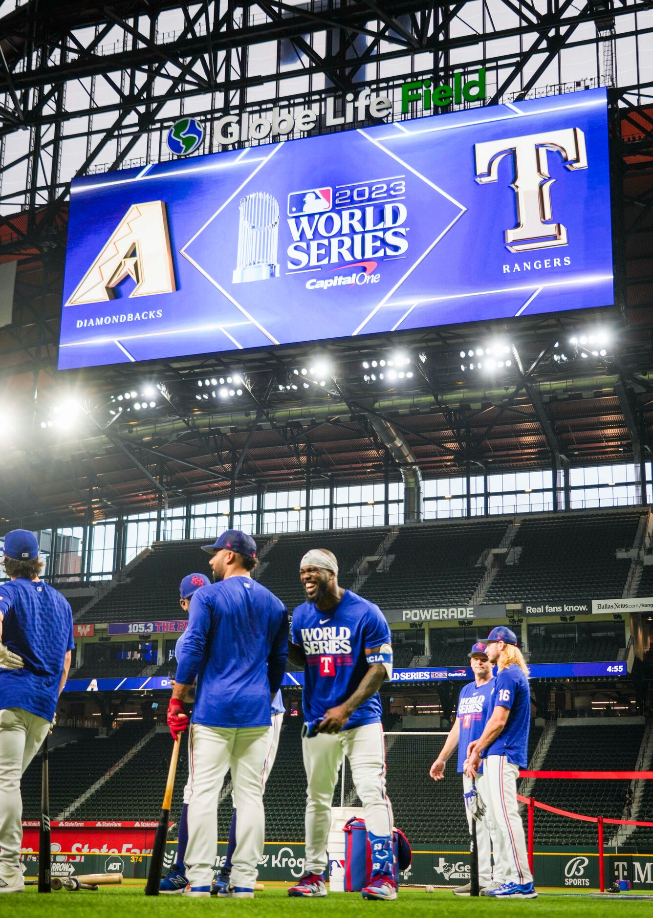 Texas Rangers right fielder Adolis Garcia (center) laughs with teammates during a team...