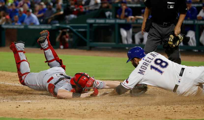 Cincinnati Reds catcher Tucker Barnhart (16) tags out Texas Rangers first baseman Mitch...