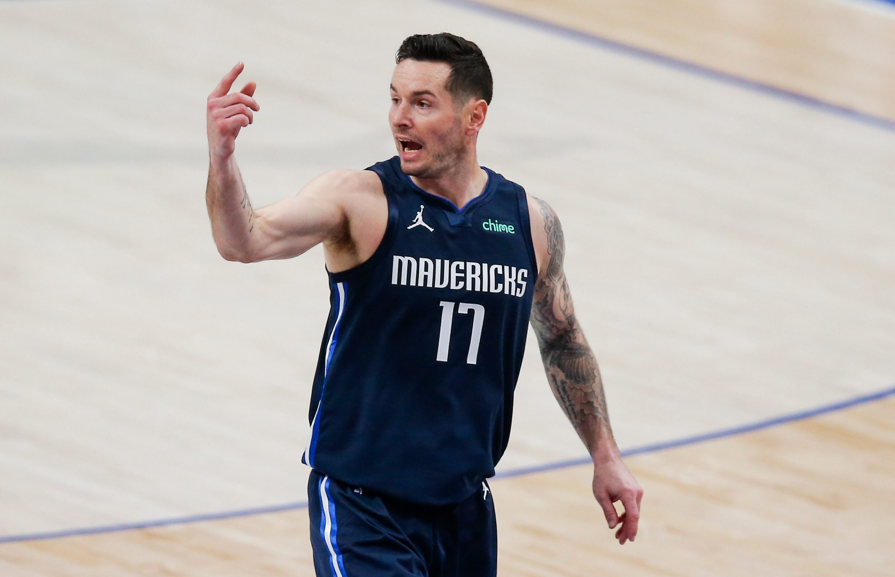 Dallas Mavericks guard JJ Redick (17) directs his teammates during the first half of an NBA...