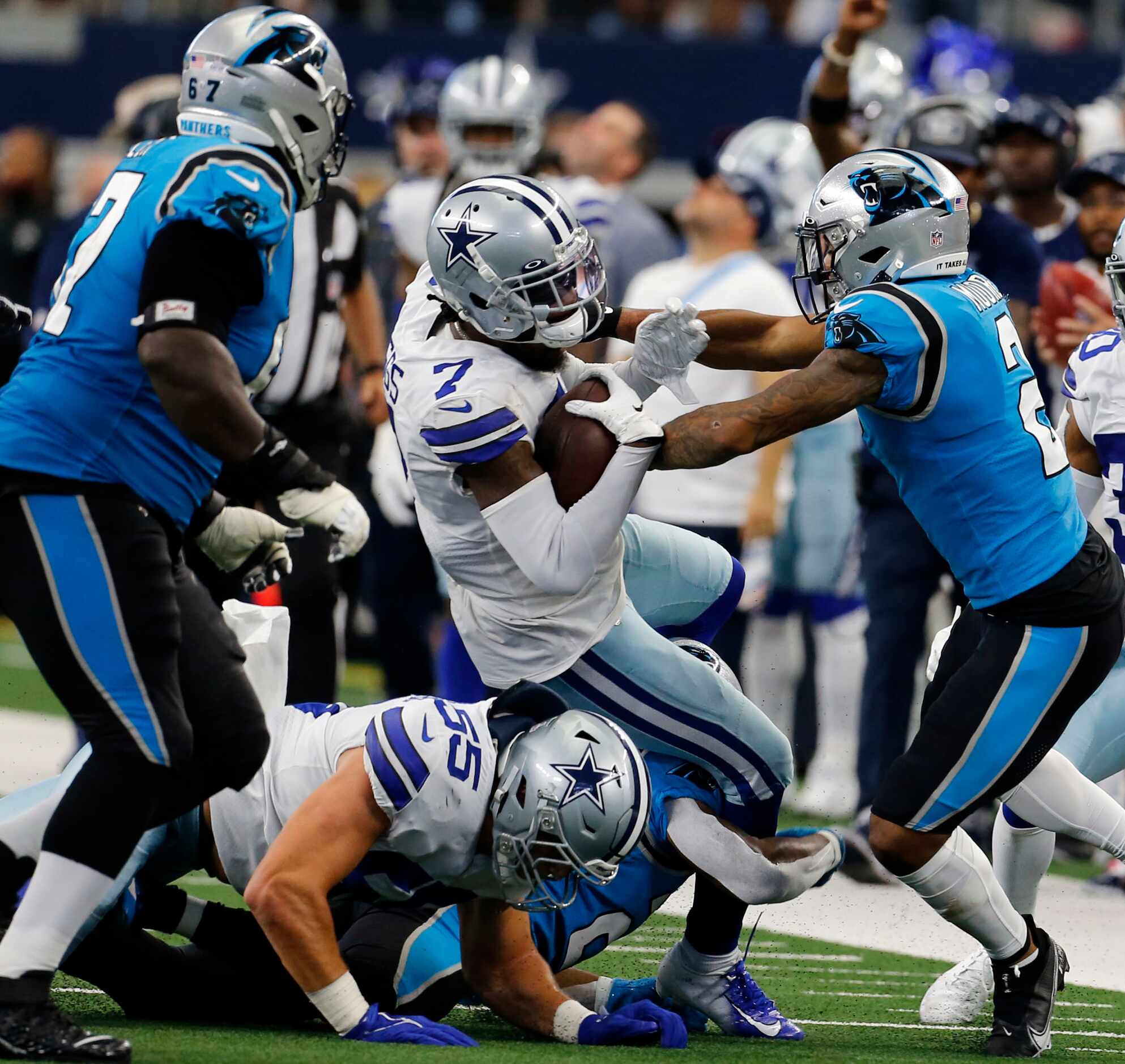 Dallas Cowboys cornerback Trevon Diggs (7) is tackled by a group of Carolina Panthers after...