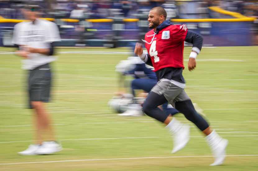 Dallas Cowboys quarterback Dak Prescott (4) runs on the field following a practice at...