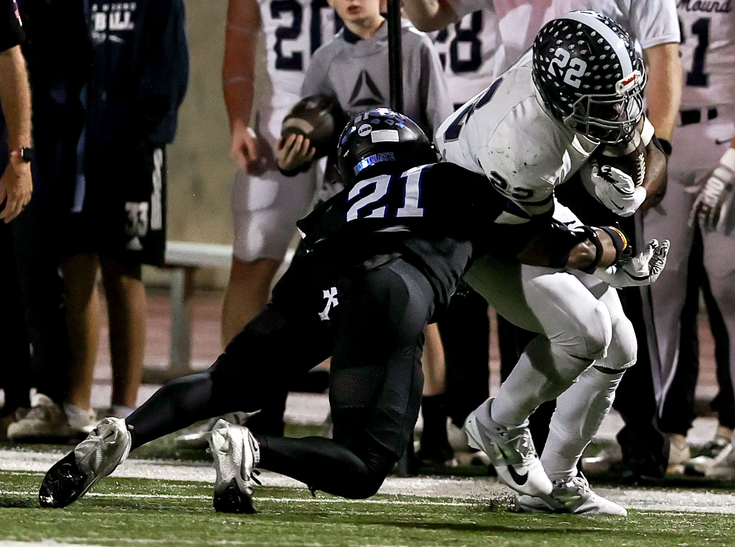 Flower Mound running back Marcus Simpson (22) is tackled by Hebron linebacker Aaron...