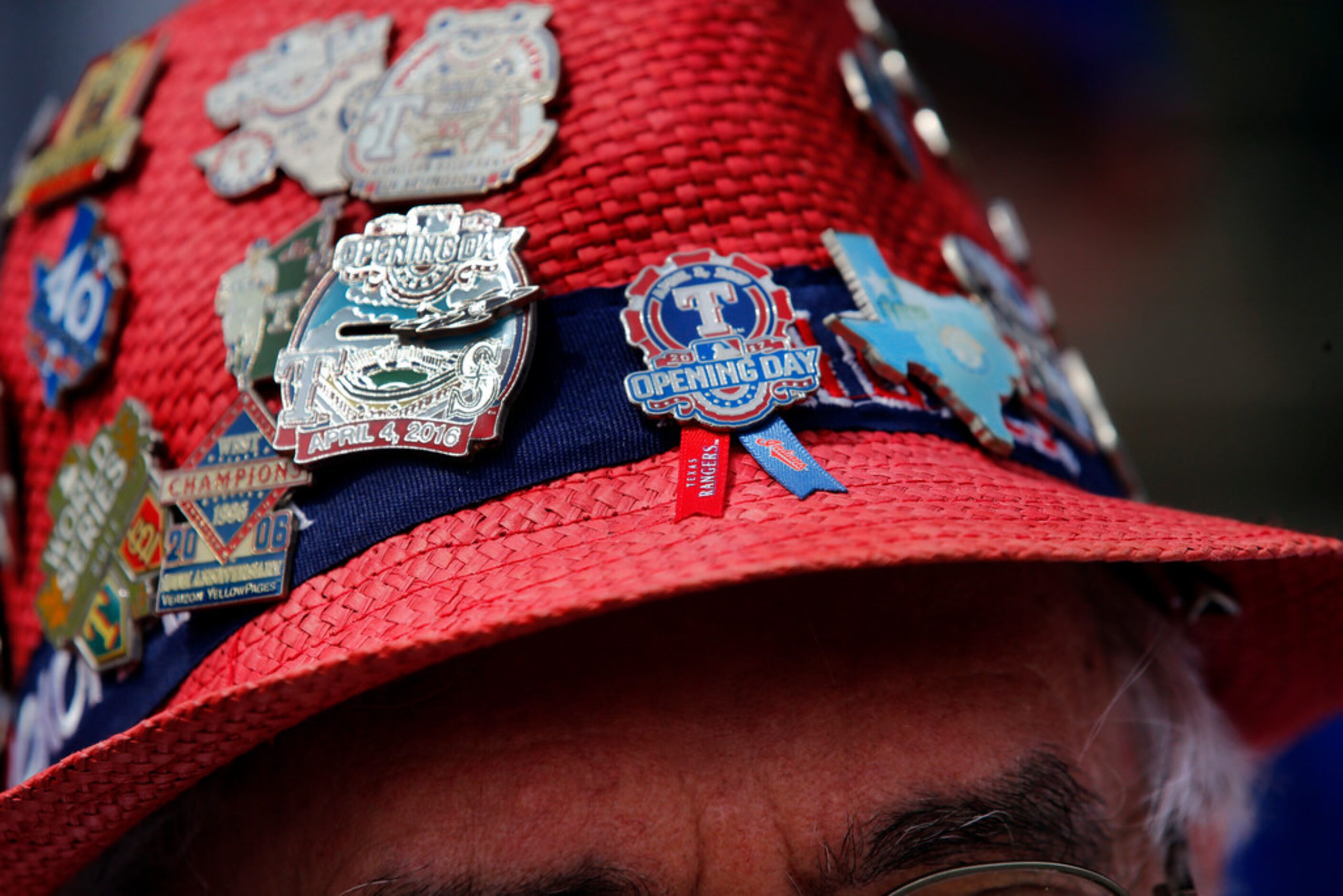 Texas Rangers fans Dana Story of Duncanville wore his old straw hat to Opening Day,...