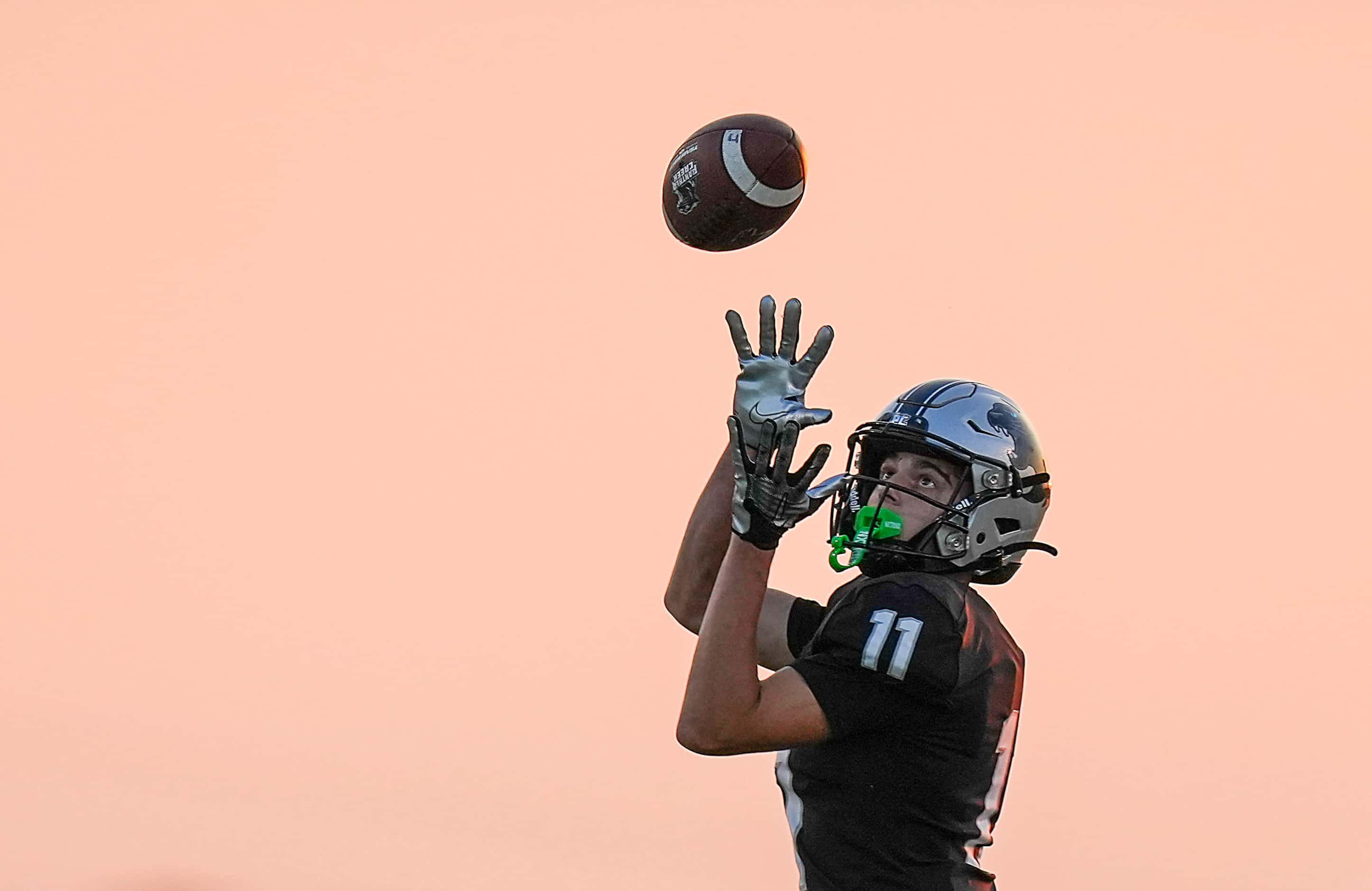 Panther Creek wide receiver Cristian Trickett (11) hauls in a pass during the first half of...
