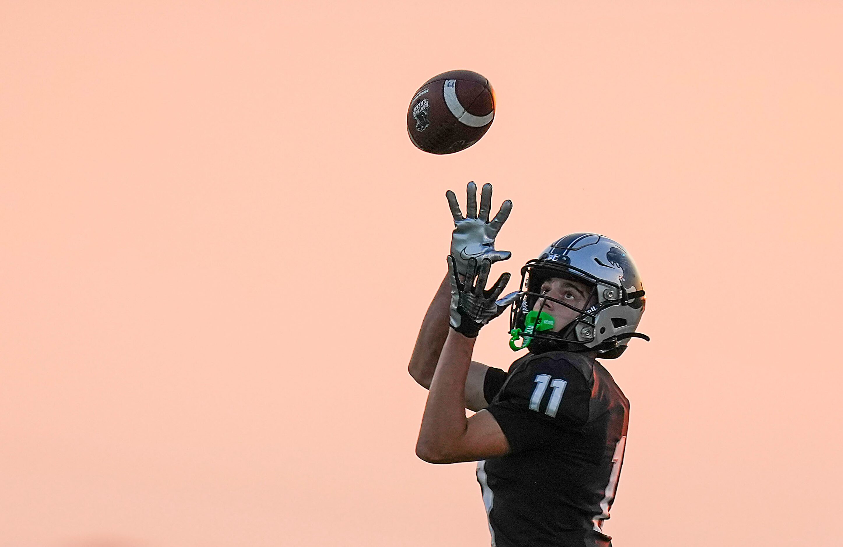 Panther Creek wide receiver Cristian Trickett (11) hauls in a pass during the first half of...