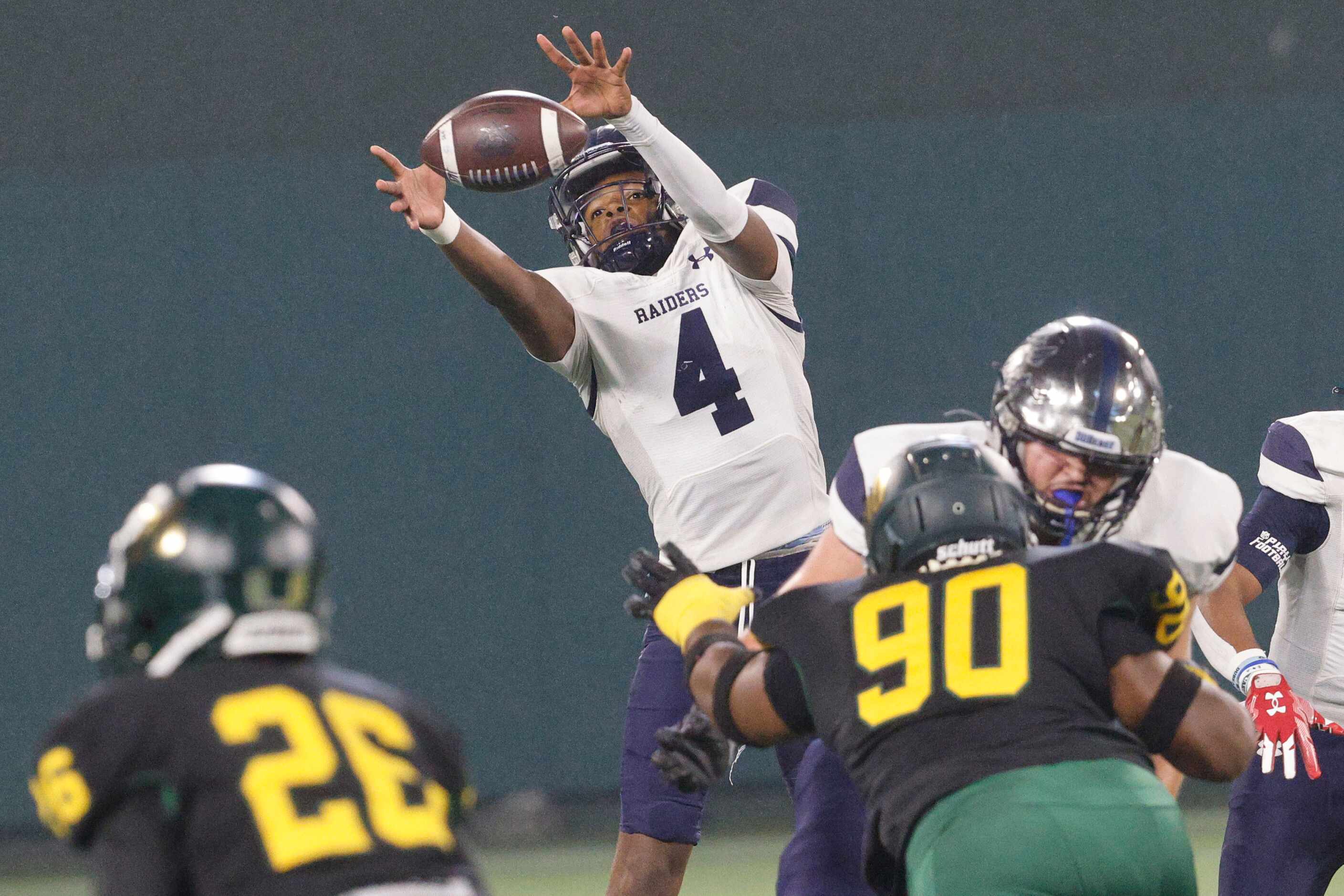 Wylie East's quarterback Howard Fisher (4) reaches out to the ball under pressure from...