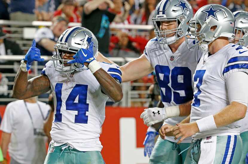 Dallas Cowboys wide receiver Lance Lenoir (14) celebrates his touchdown with quarterback...