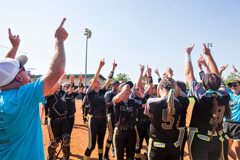 Forney coach Pat Eitel and his players point to the sky to remember Emily Galiano after...