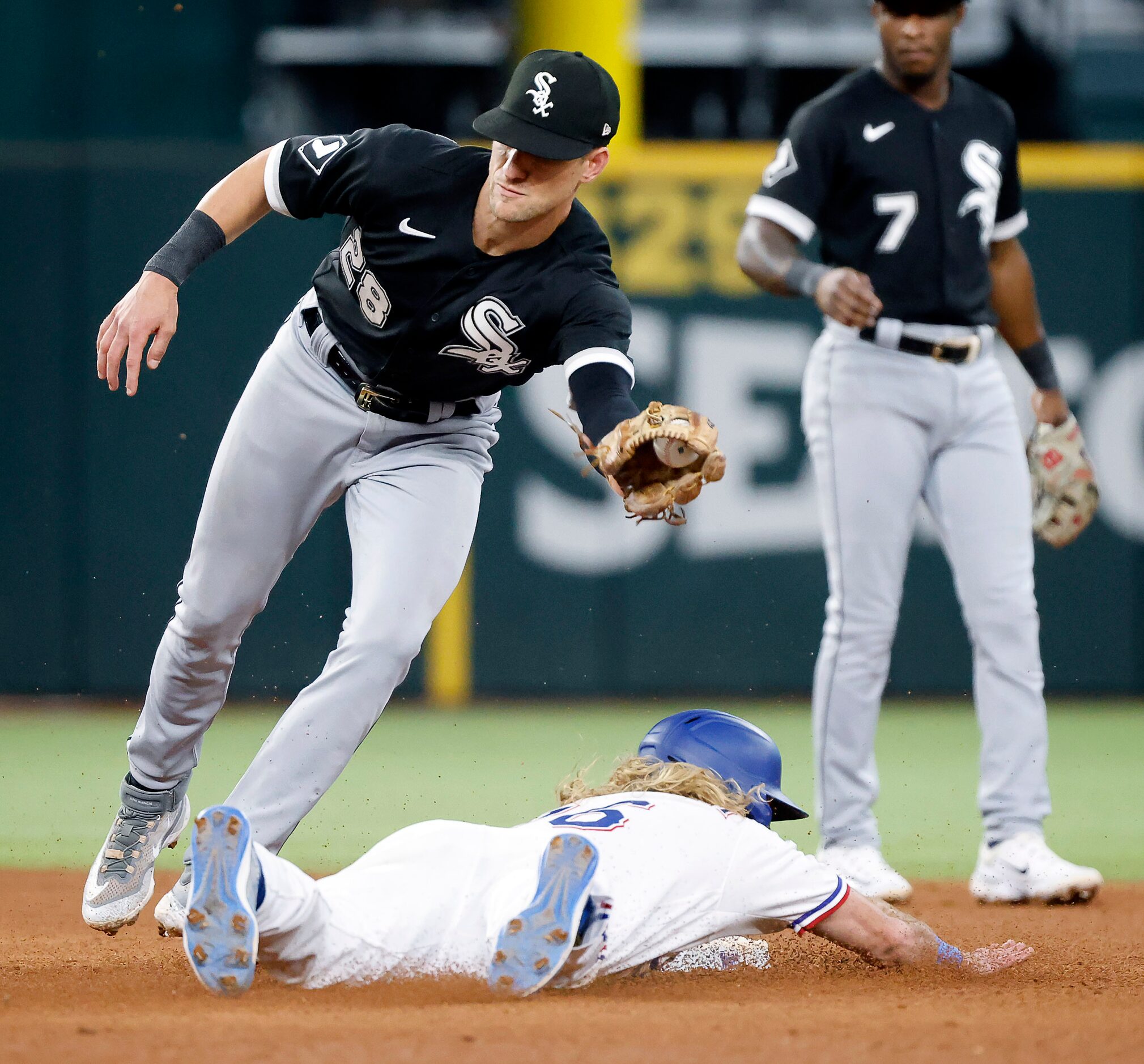 Texas Rangers Travis Jankowski (16) dives into second base on a stolen base against Chicago...