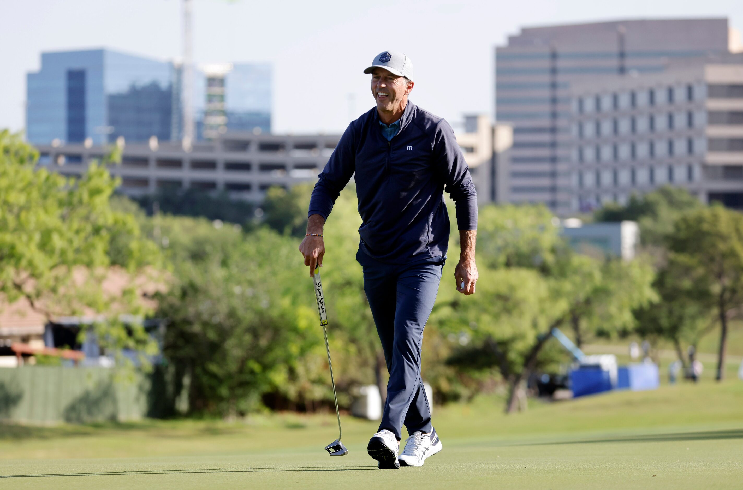 Former Dallas Stars player Mike Modano laughs as he finishes out No. 11 with former Dallas...