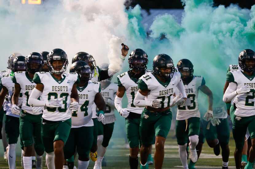DeSoto high players enter the field ahead of their game against Lake Ridge High during a...