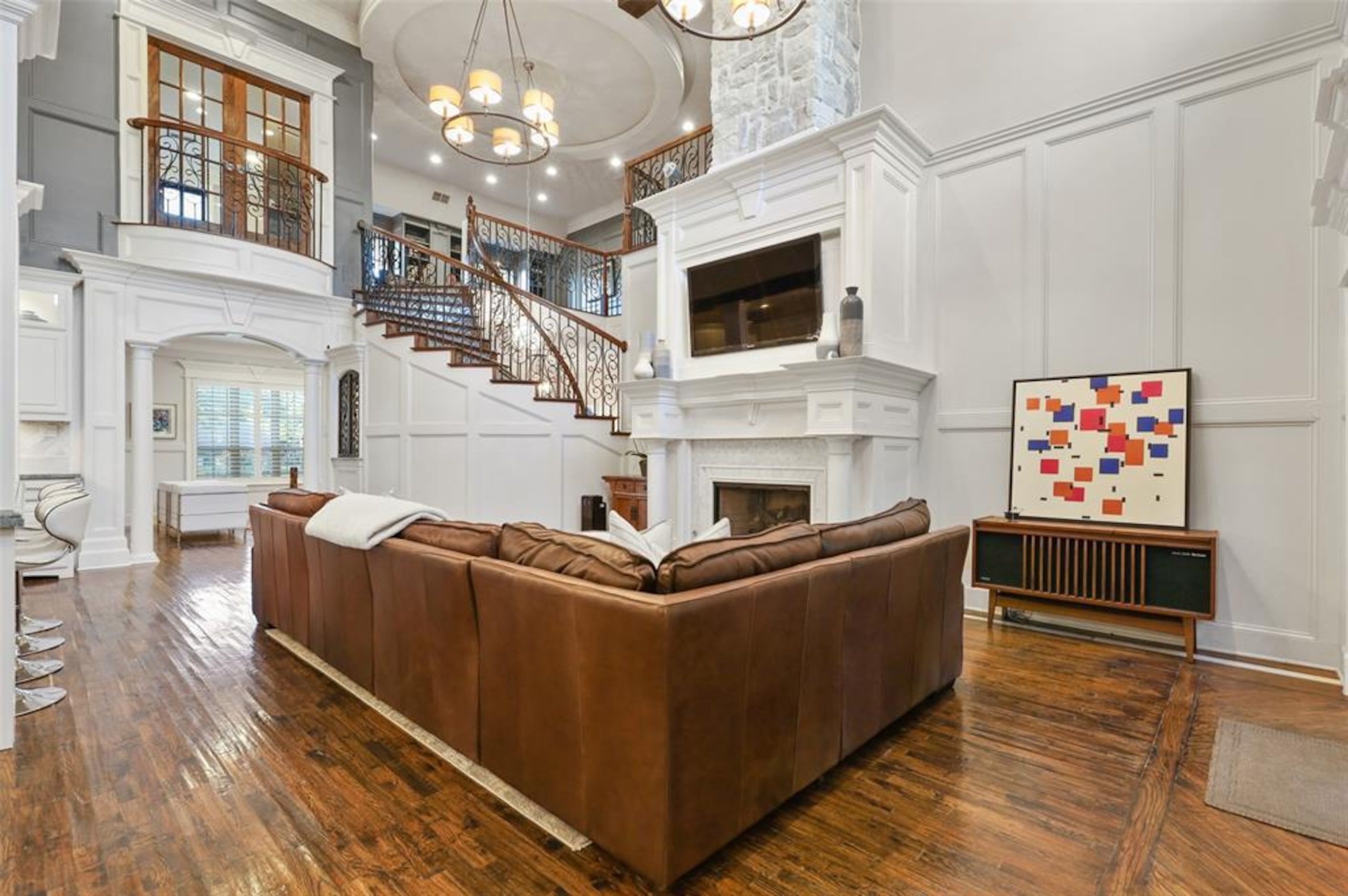 The kitchen overlooks the great room, which features an impressive fireplace.