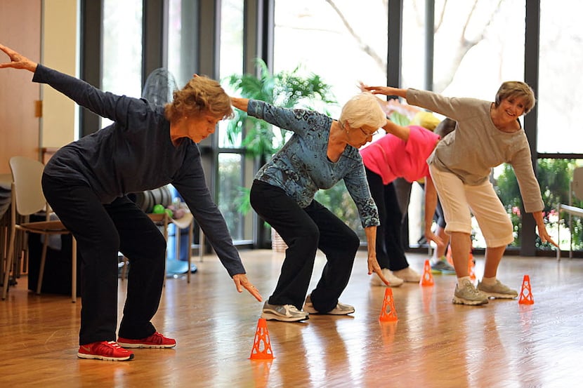 Marianne Griffin (left) of Allen performs an exercise during a Strength and Balance class at...