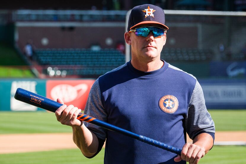 Houston Astros manager AJ Hinch watches batting practice before a game against the Texas...
