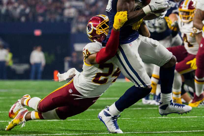 Dallas Cowboys wide receiver Dez Bryant (88) is tackled by Washington Redskins cornerback...