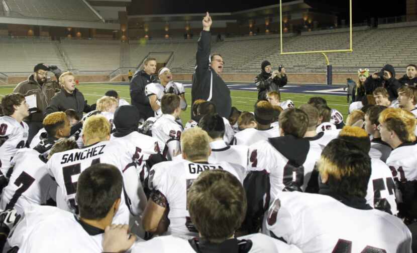 Wylie head coach Bill Howard leads his team in celebrating following their victory over...