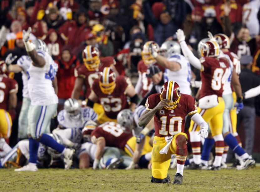 Washington Redskins quarterback Robert Griffin III (10) celebrates after Washington Redskins...