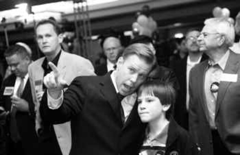  Wade Emmert, the Republican county judge candidate, watched early race results with son...