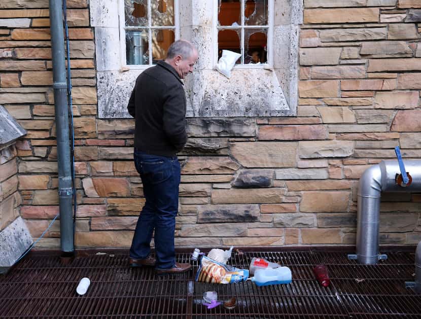Church member Tom Leavens examines some of the damage to the education building of St....