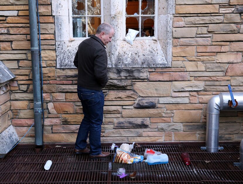 Church member Tom Leavens examines some of the damage to the education building of St....