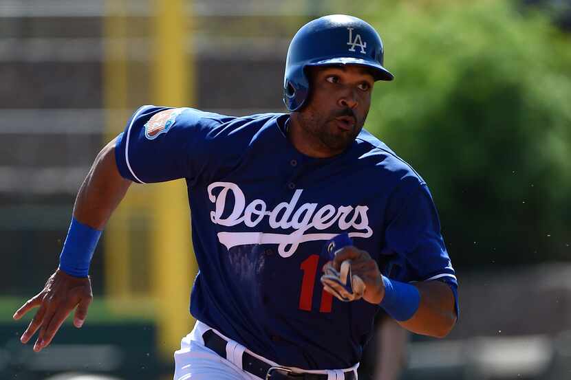 GLENDALE, AZ - MARCH 14:  Micah Johnson #11 of the Los Angeles Dodgers rounds the bases to...
