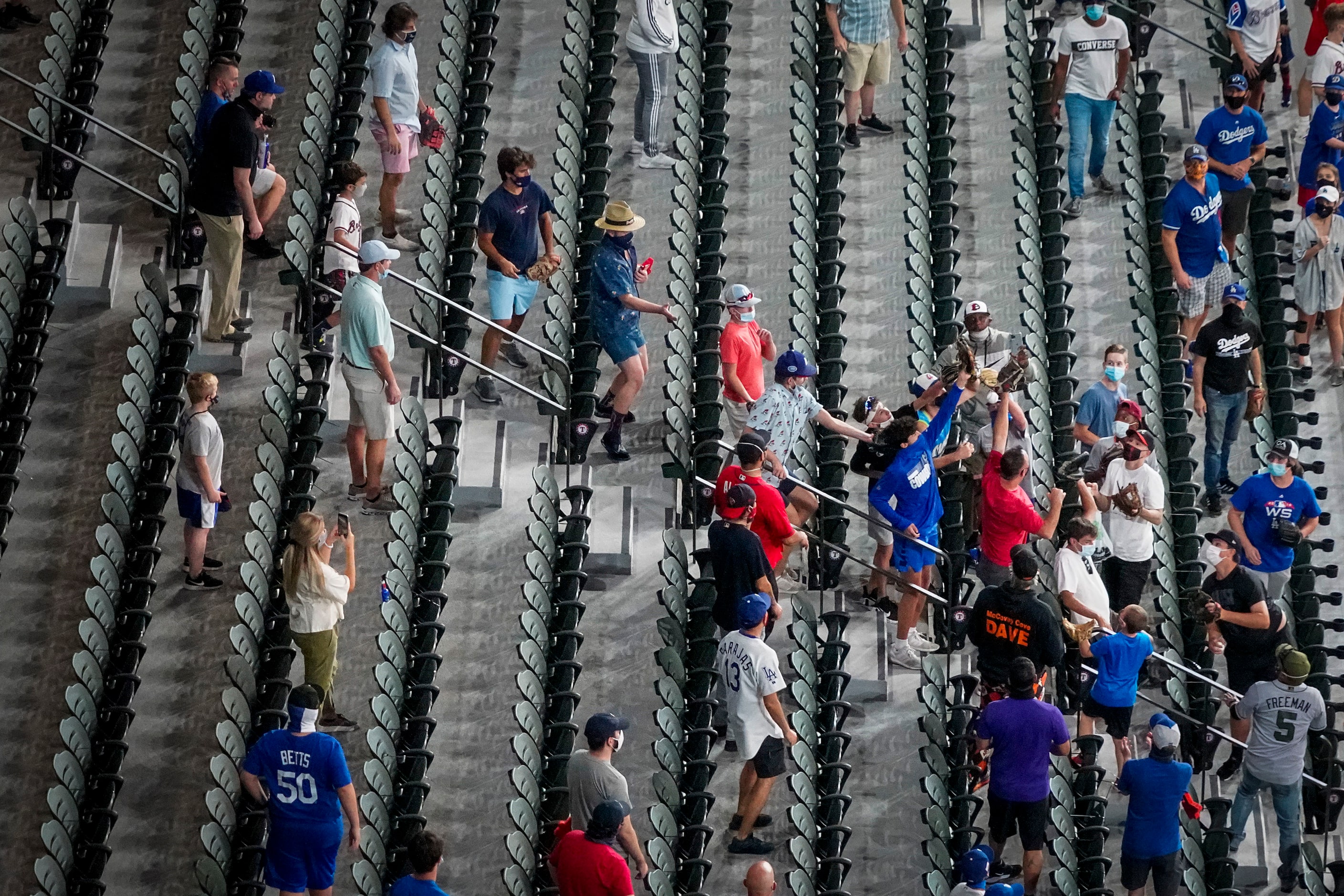 Fans in the right field stands reach for a home run ball during batting practice before Game...