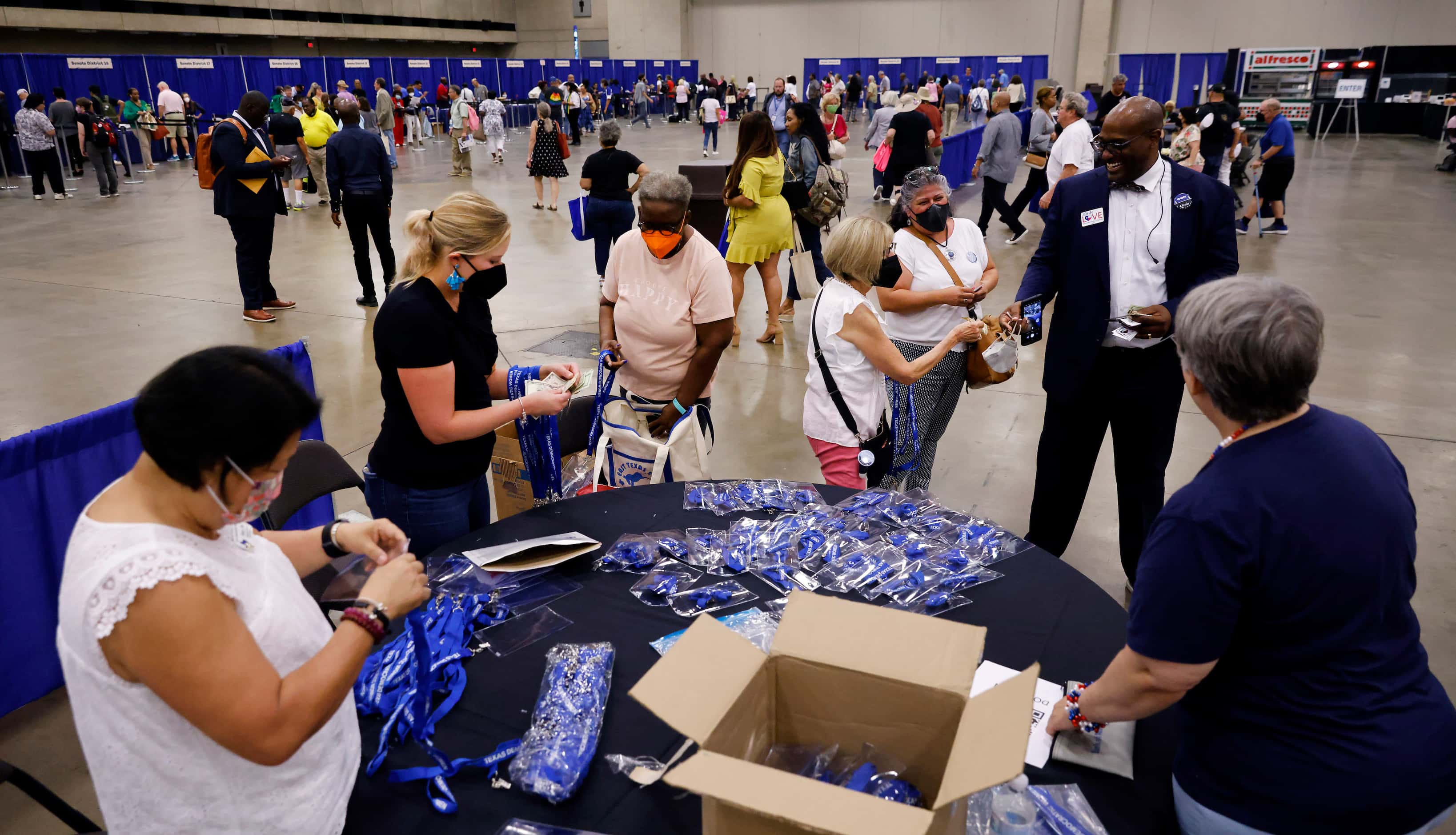 Volunteers sell convention lanyards to delegates after they’ve picked up their credentials...
