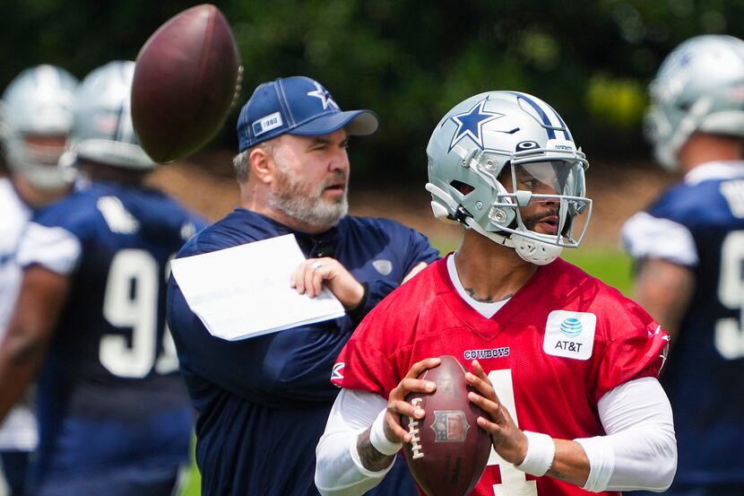 Dallas Cowboys head coach Mike McCarthy watches quarterback Dak Prescott (4) run a drill...