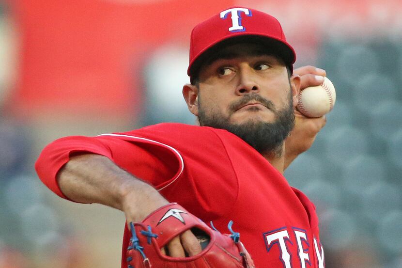 Texas Rangers starting pitcher Martin Perez (33) throws a first-inning pitch during the Los...