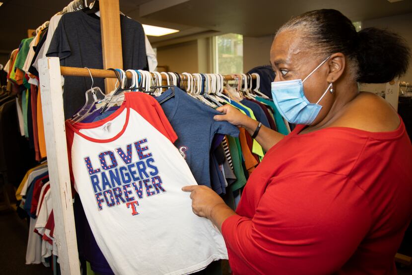 Dawn Shepard pulls out some Rangers shirts she has at Broadway Baptist Church's clothes...