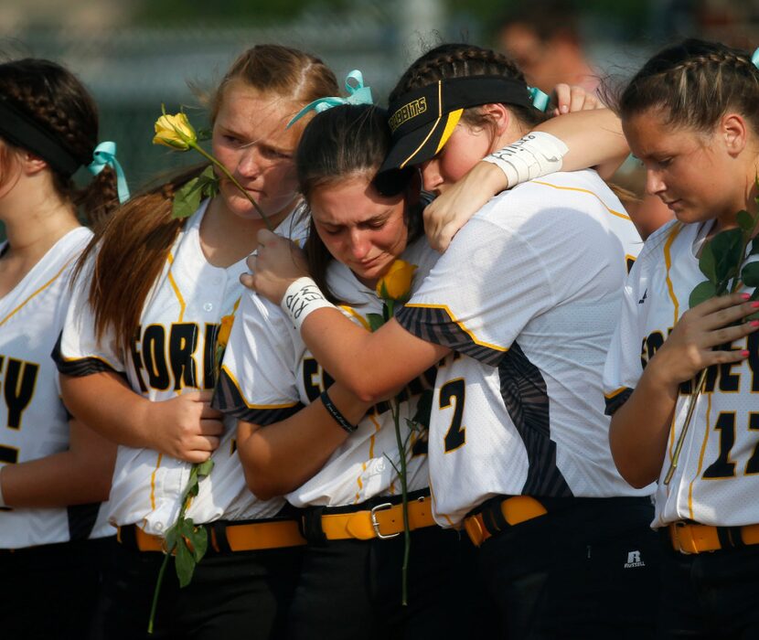 Forney softball players Sam Coker (1, left) and Savannah DesRochers (2, right) embrace...