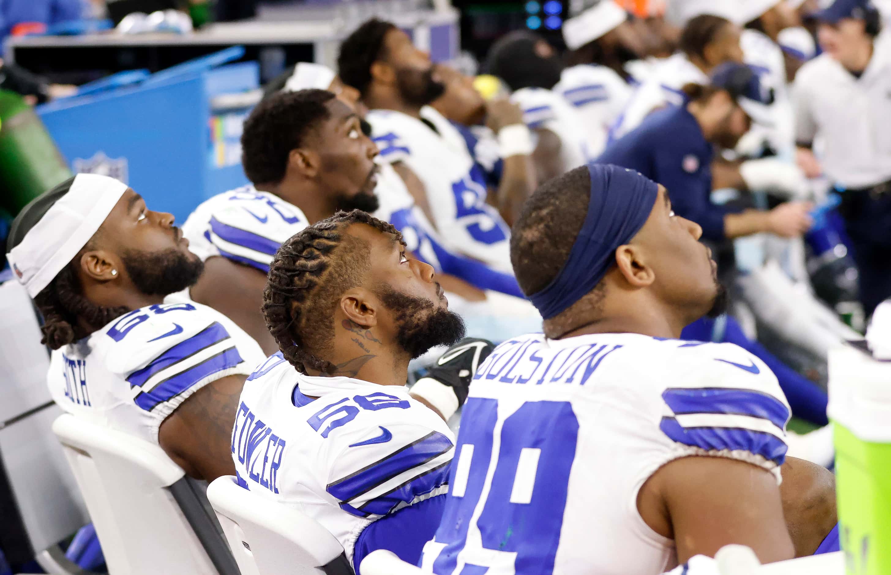 The Dallas Cowboys defense watches the closing minutes of the game on the video board in...
