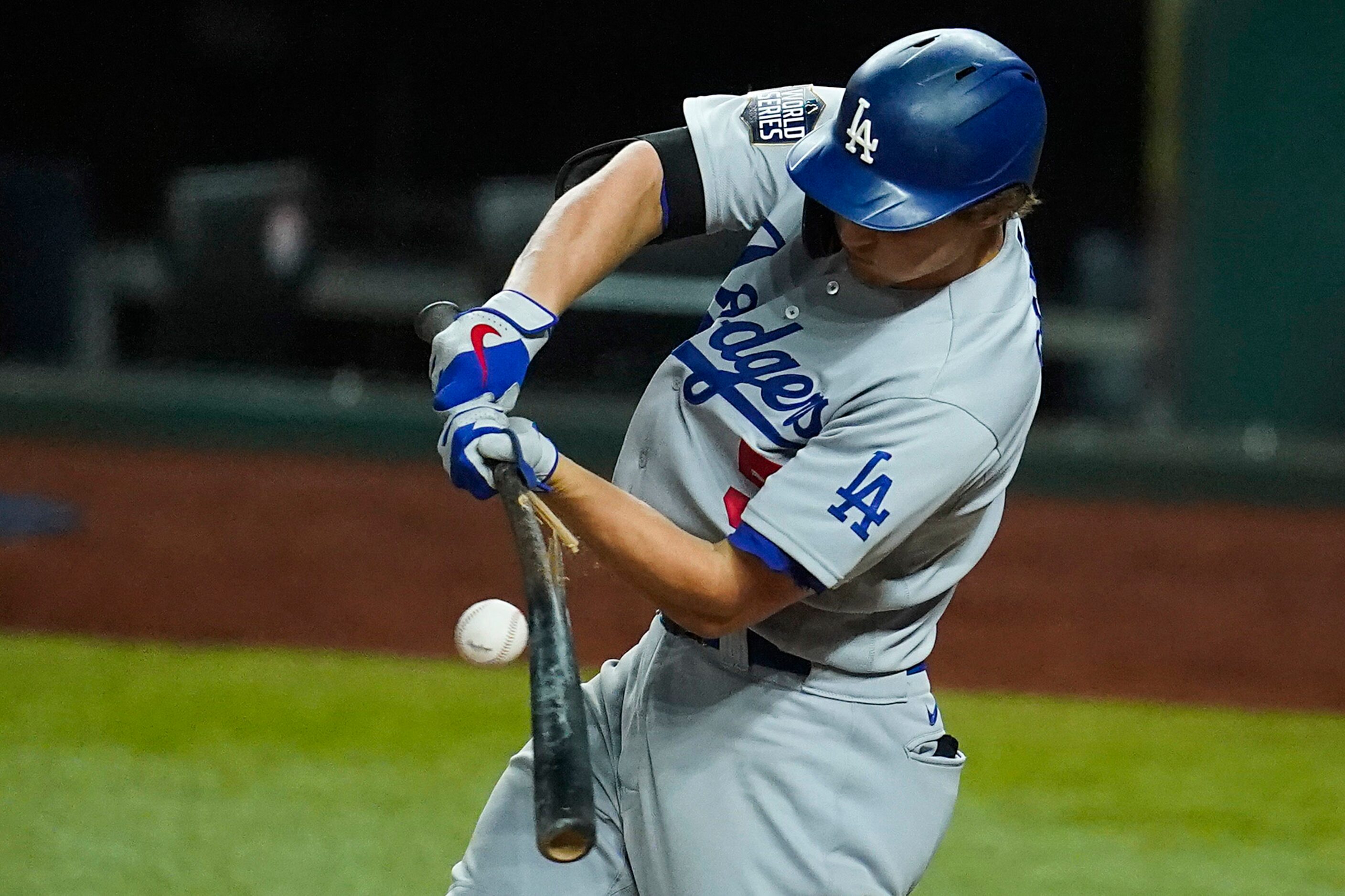 Los Angeles Dodgers shortstop Corey Seager breaks his bat on a single during the ninth...