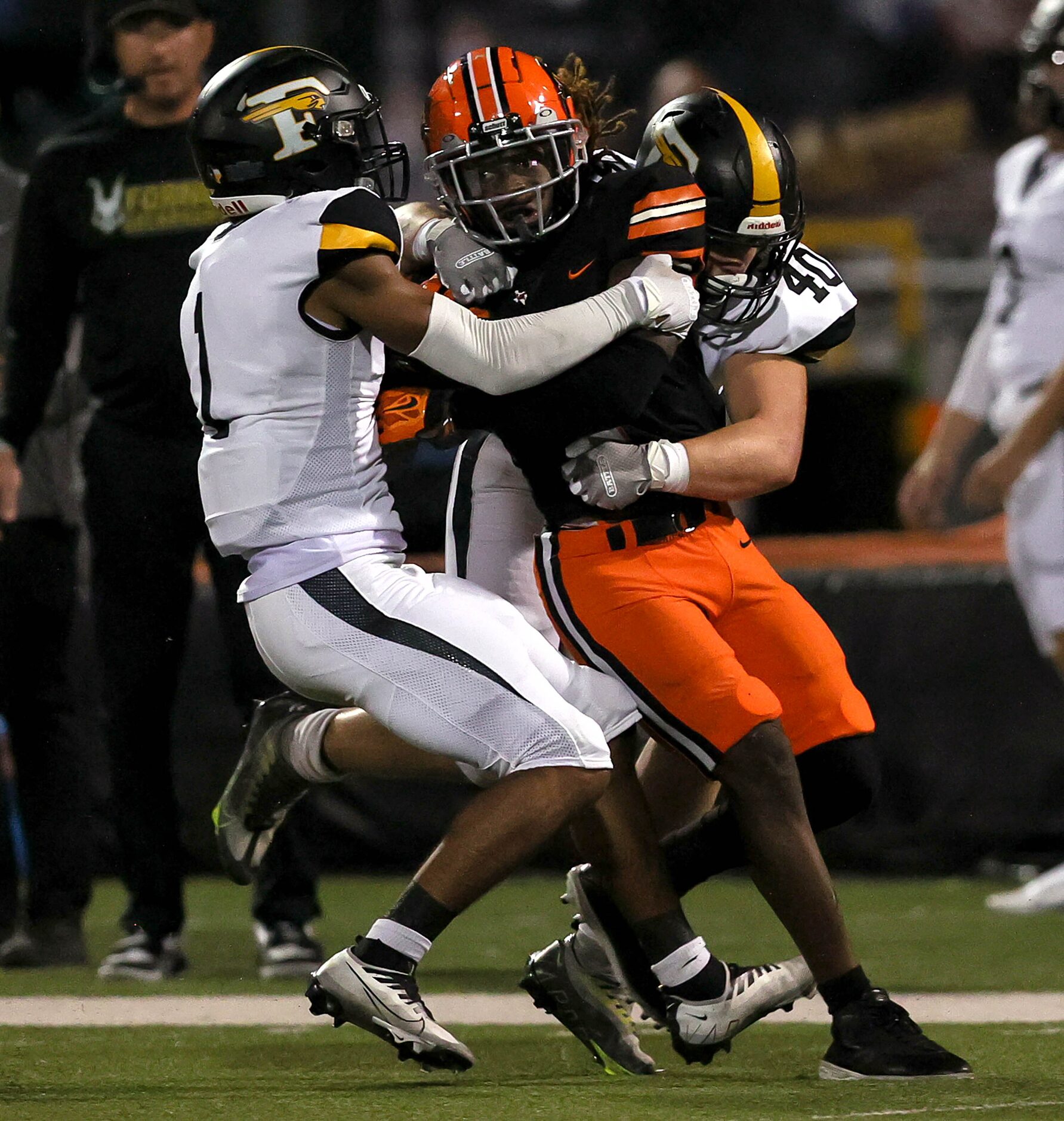 Lancaster running back Kyson Brown (1) fights for yardage against Forney defensive back...