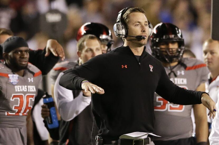 Texas Tech coach Kliff Kingsbury sends signals to his team during the first half of the Dec....
