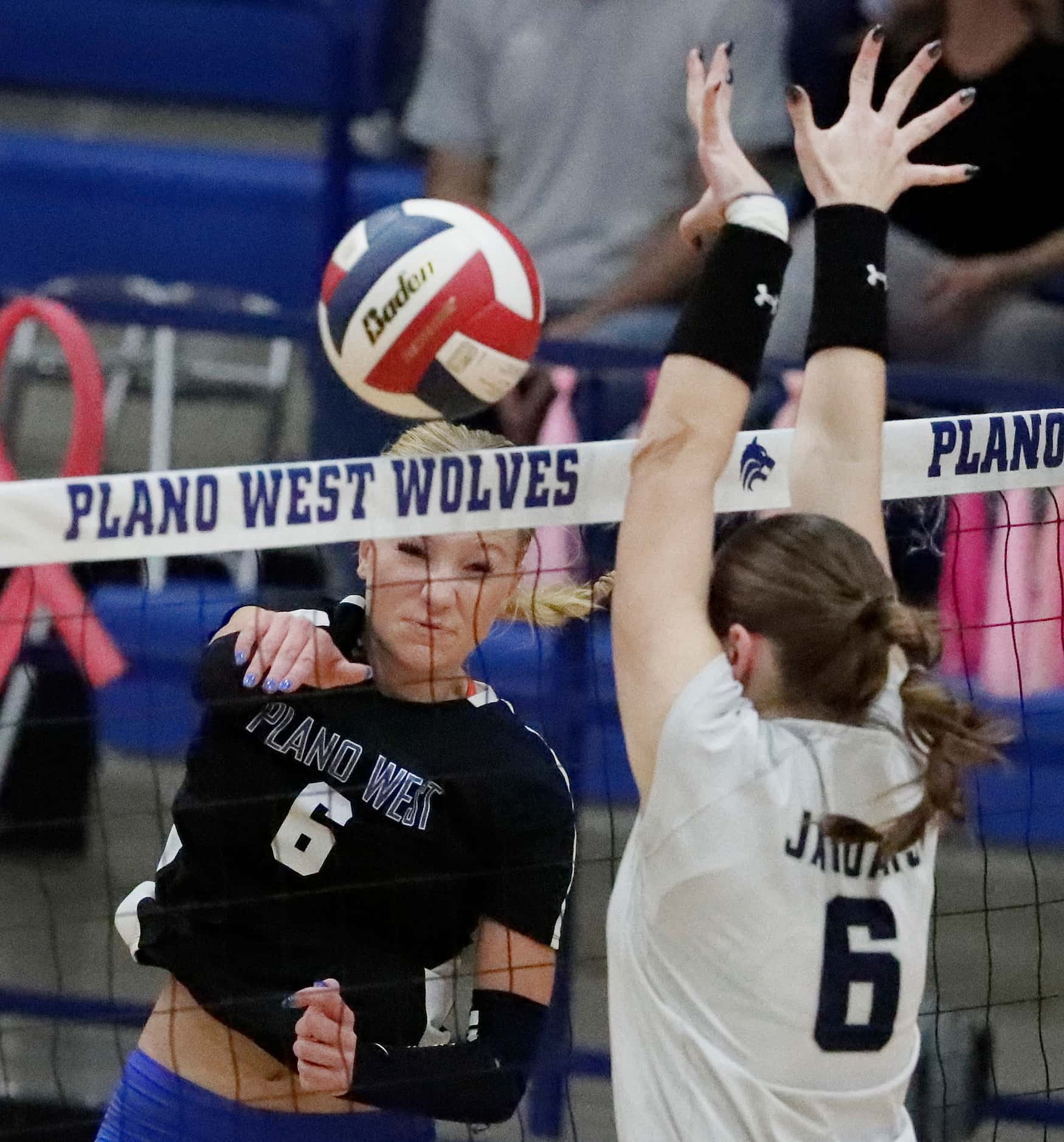 Plano West High School outside hitter Blaire Bowers (6) gets a hit past Flower Mound High...