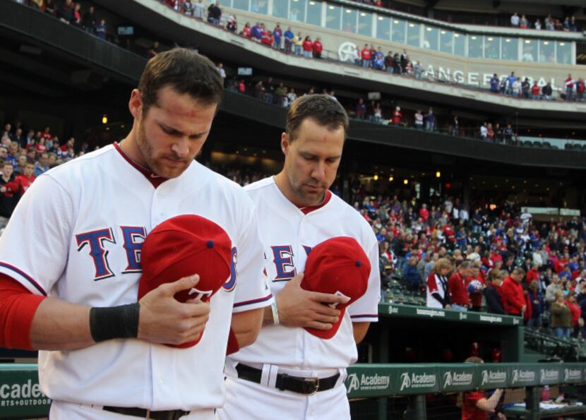 Texas Rangers player Nelson Cruz is congratulated by Michael Young and Adrian Beltre after...