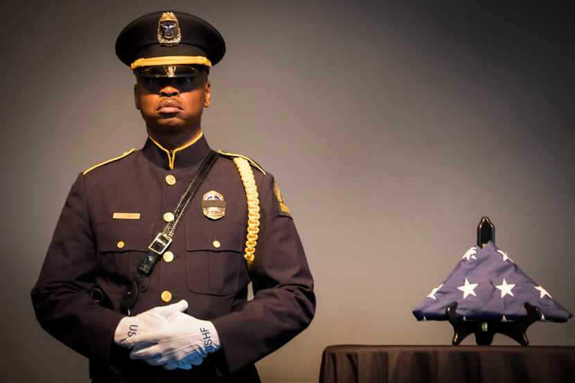 Dallas Police Sgt. Michael Bables stood beside the U.S. Honor Flag at Dallas police...