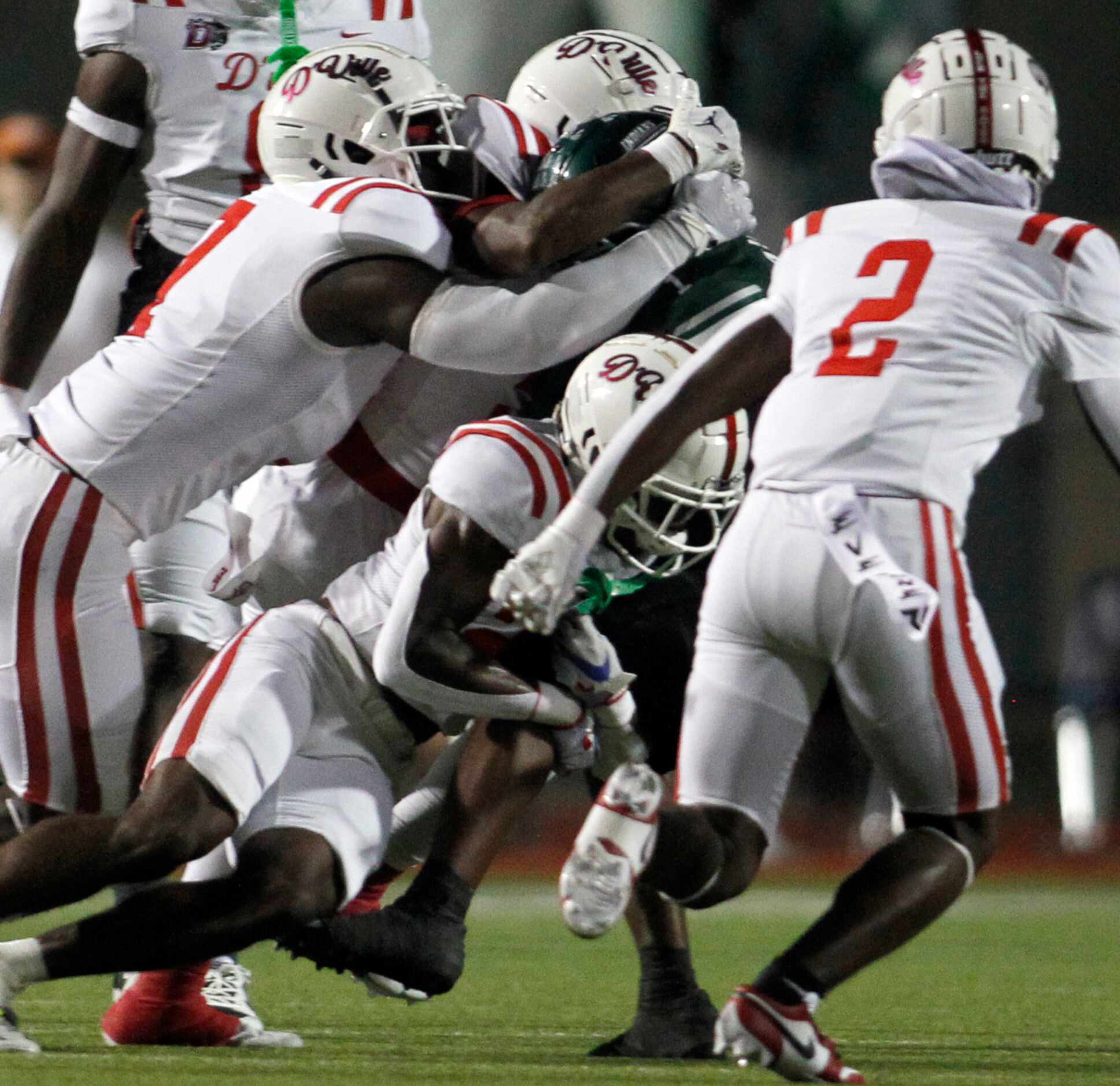 Waxahachie receiver Trenton Kidd (1) is swarmed by the Duncanville defense following a...