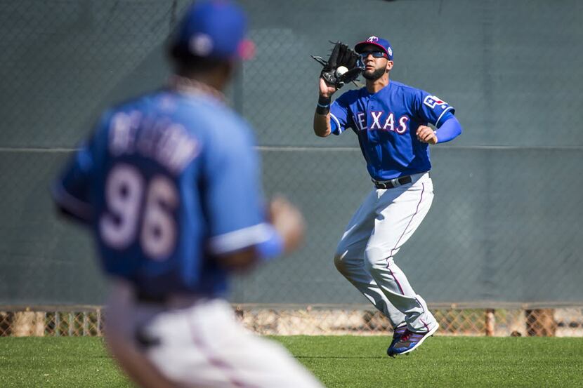 Texas Rangers outfielder Nomar Mazara makes a catch in right field during a spring training...