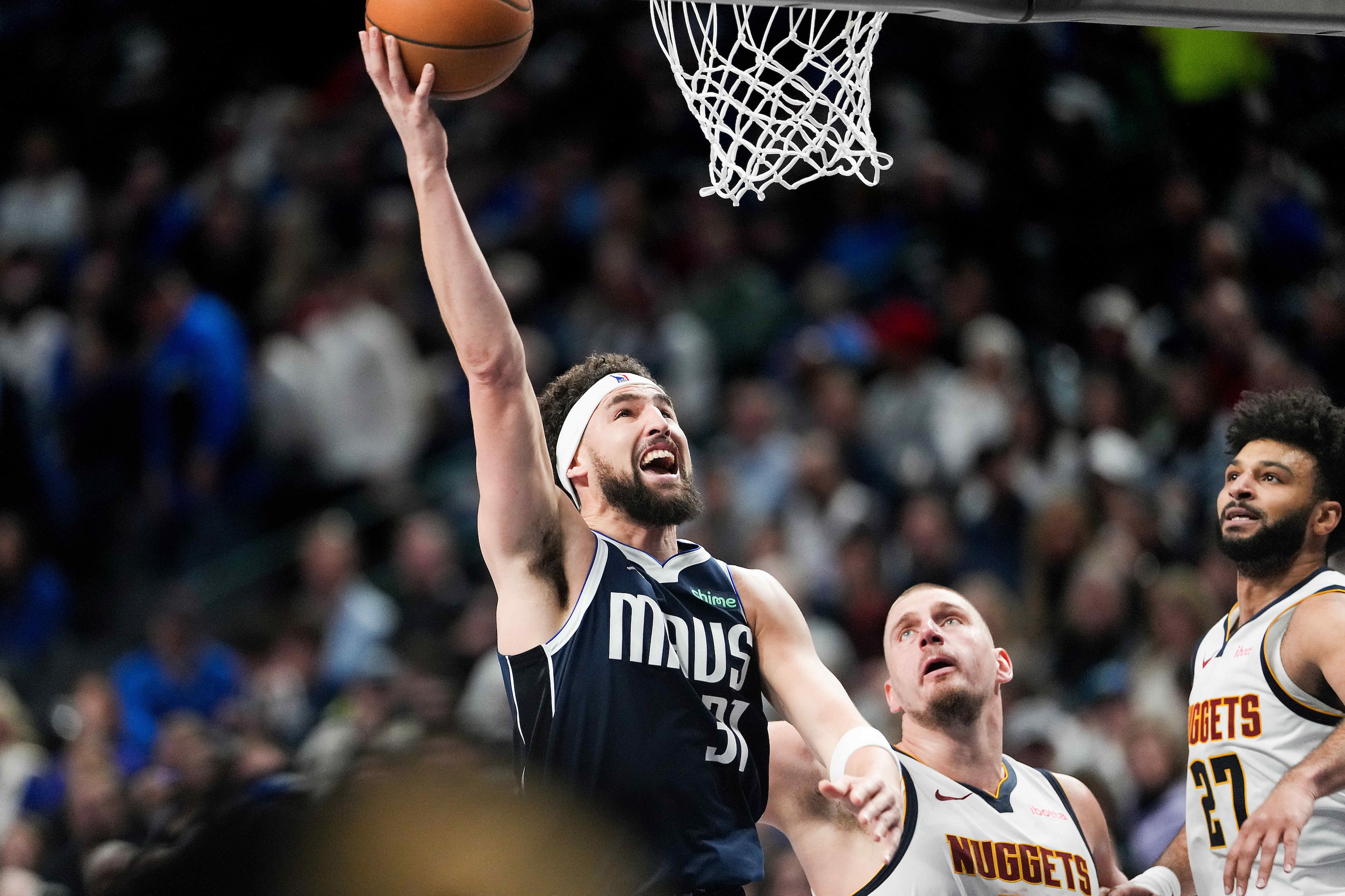 Dallas Mavericks guard Klay Thompson (31) scores past Denver Nuggets center Nikola Jokic...