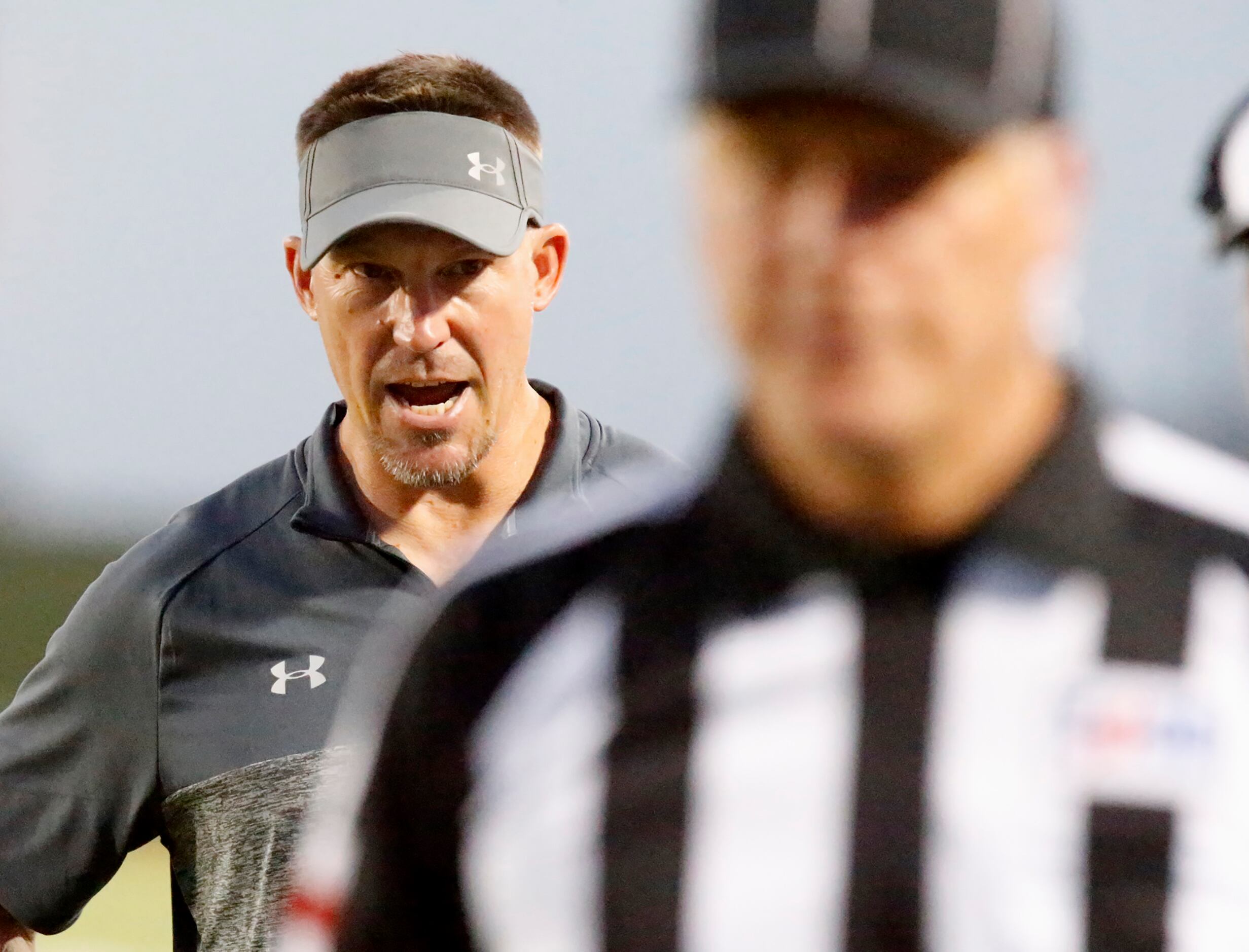 Lake Dallas High School head coach Michael Young tries to question a ref during the first...