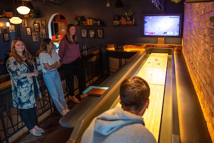 Electric Shuffle in Deep Ellum has 17 shuffleboard tables. Groups can play four shuffleboard...