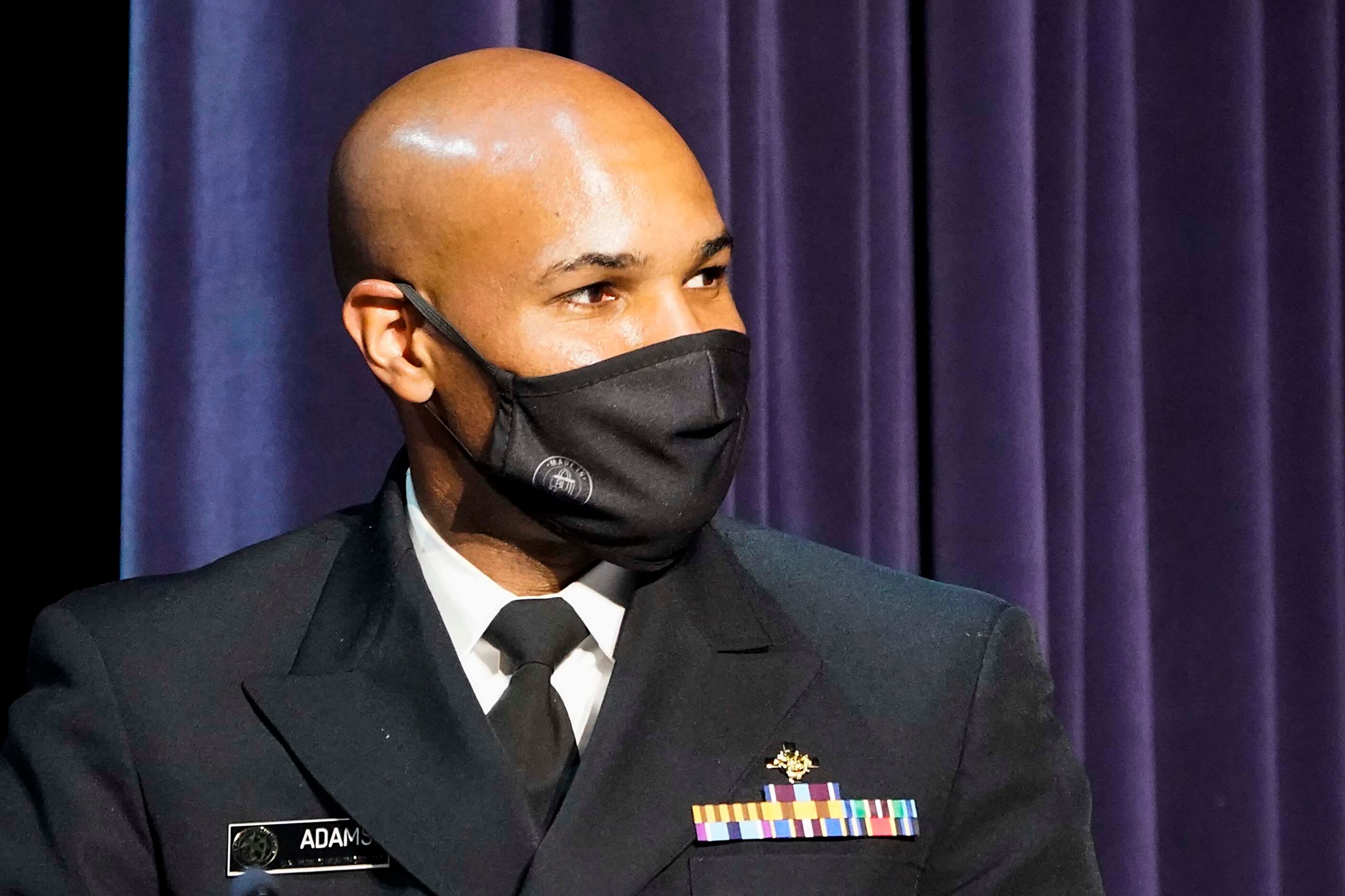 Surgeon General Jerome Adams listens to a speaker during a roundtable conversation about...