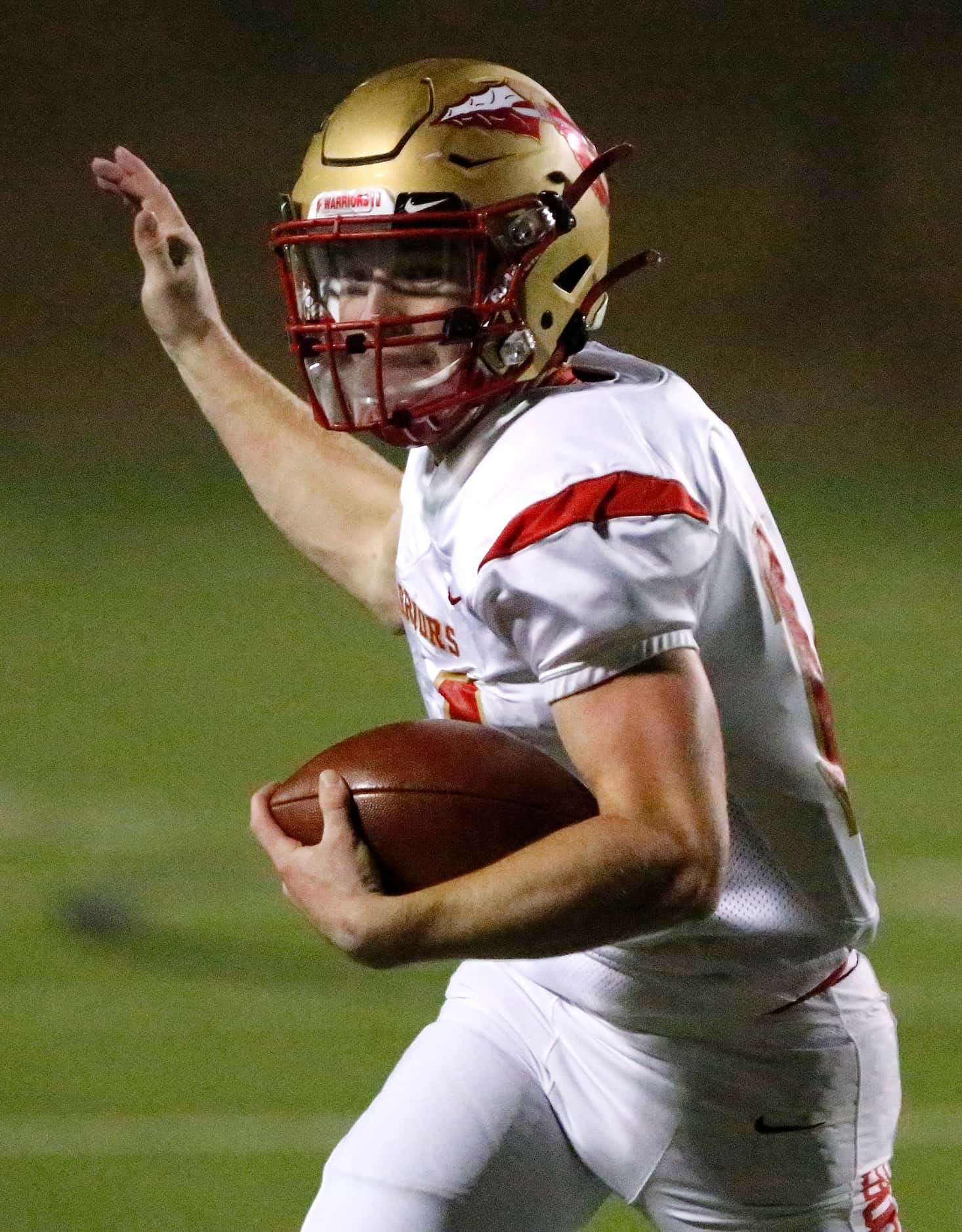 South Grand Prairie High School quarterback Sean Stegall (14) keeps the football for a big...
