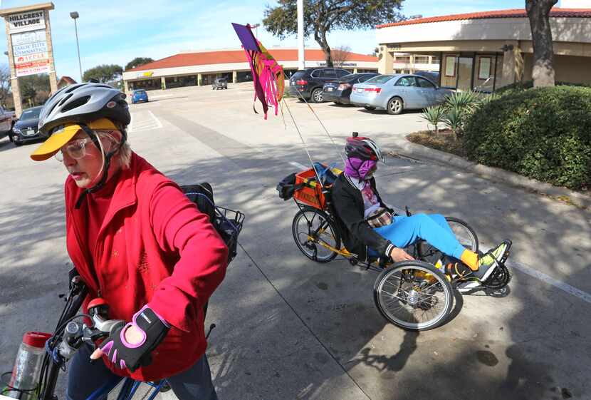 Jeffrey Weiss, right, maneuvers his recumbent tricycle as his wife Marni gets set to ride...